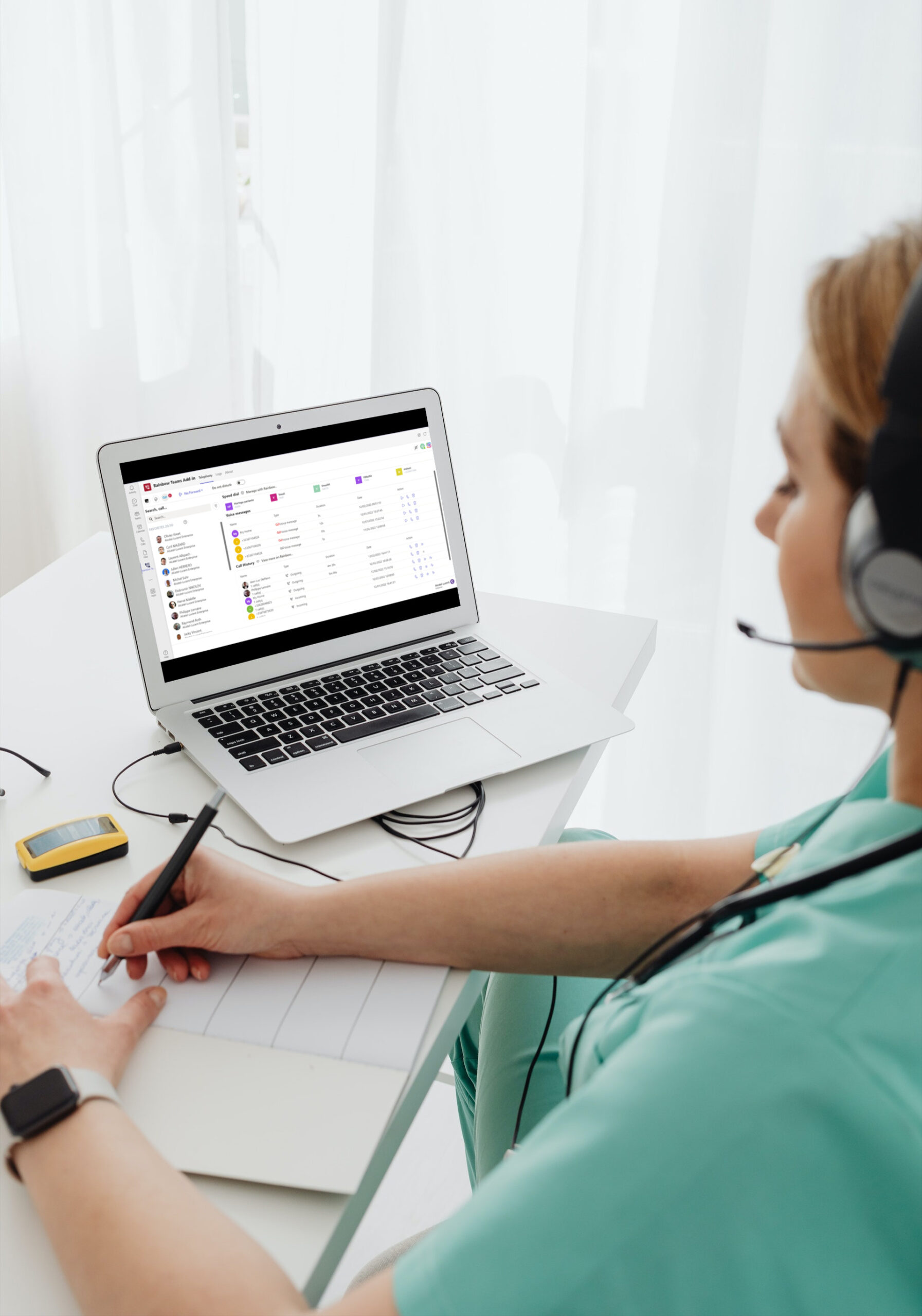 Woman with a headset  taking notes aside from using the connector Rainbow Telephony for Microsoft Teams