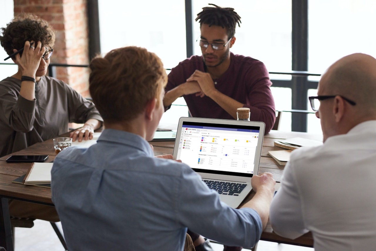 A group of professional working in group while one person use Rainbow Telephony for Microsoft Teams