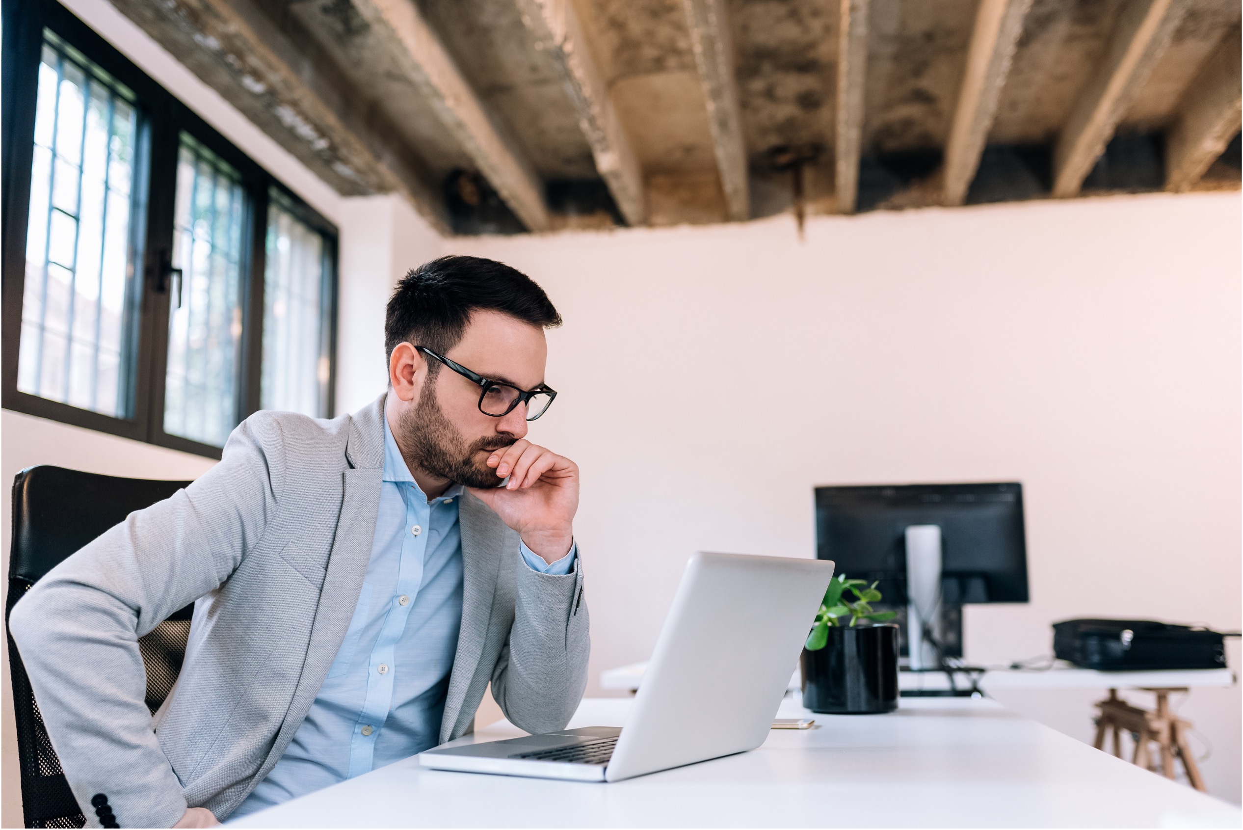 man scratching head while thinking about what feedback to give