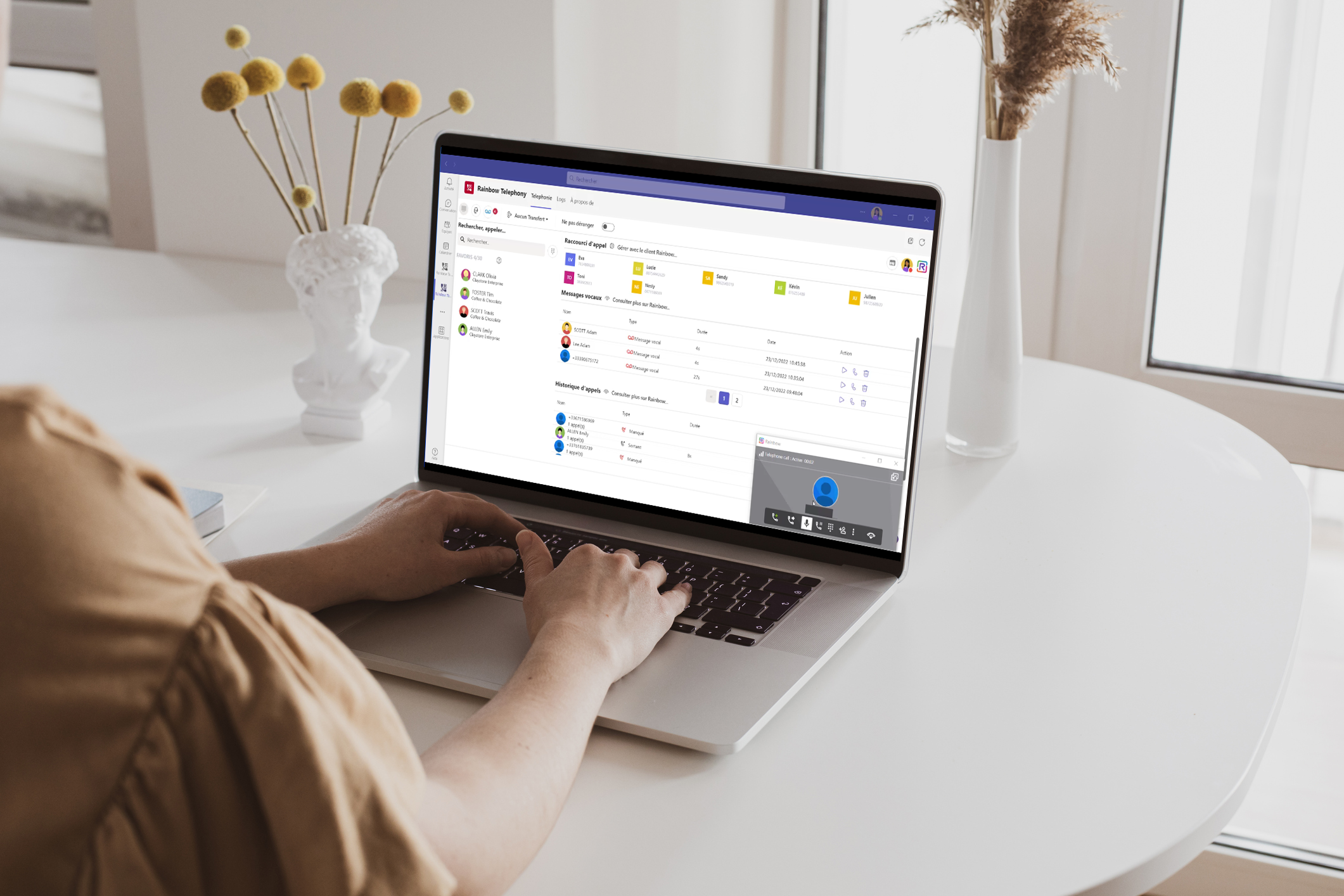 woman typing on her laptop while using Rainbow Telephony for Microsoft Teams